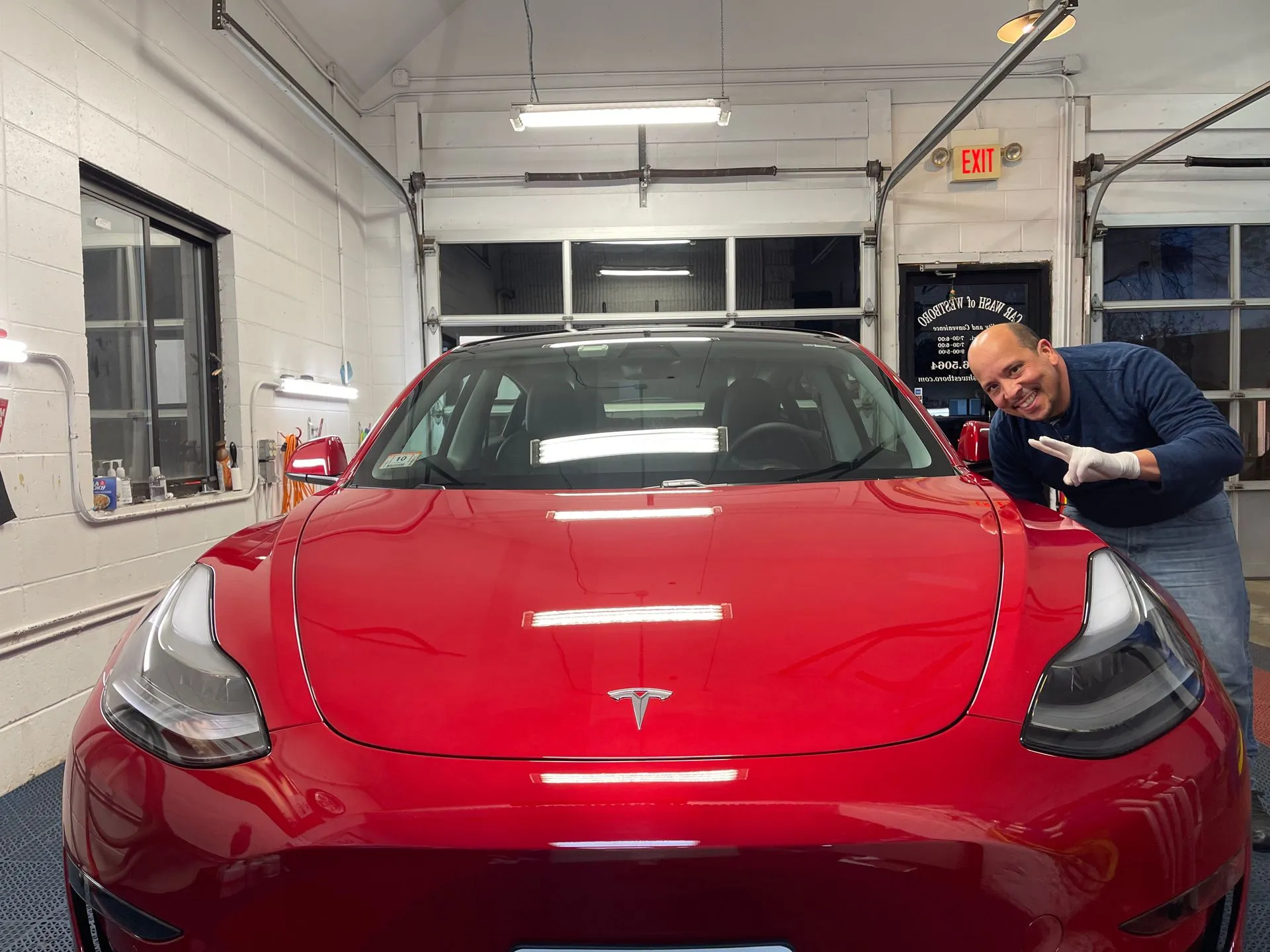 Mariano detailing red Tesla Model 3 — MVN Detailing
